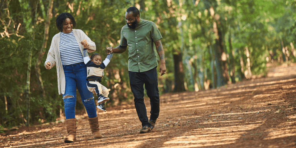 Parents playing with toddler during walk at Sandy Bottom Nature Park