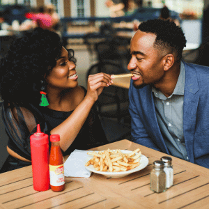 Feeding her spouse fries at date night at Marker 20 in Hampton, VA