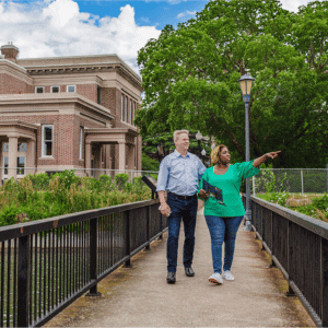 couple at fort monroe on walkway pointing