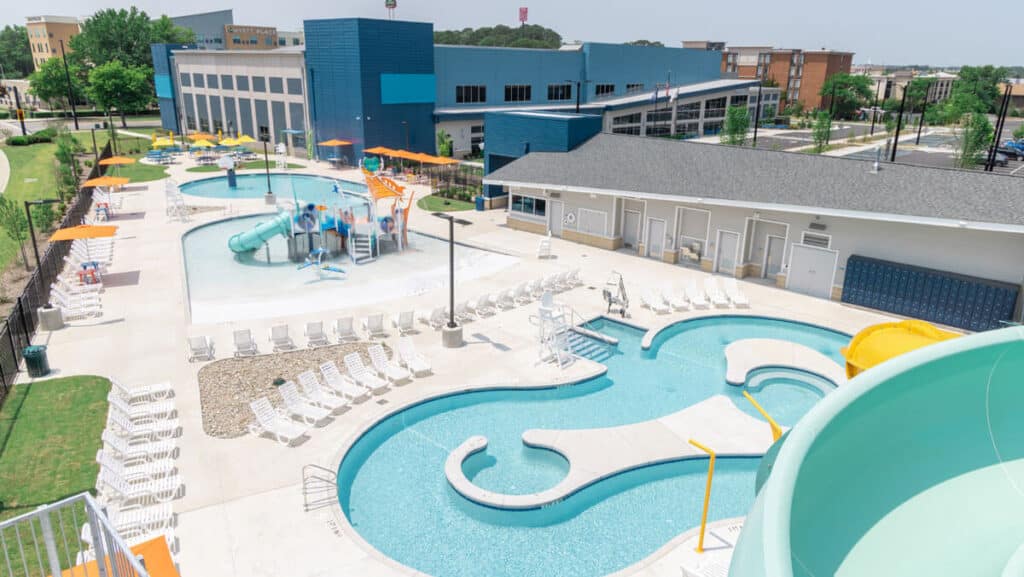 aerial view of Splashdown Park at Hampton Virginia Aquaplex. You can see the lazy river, play pool and play structure, lounge chairs, and picnic tables.