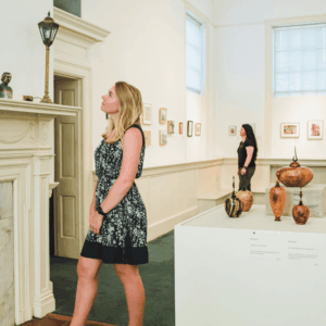 Women browse the exhibits at Charles H Taylor Visual Arts Center