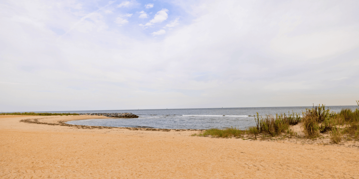 One of the sandy beach coves of Outlook Beach at Fort Monroe.