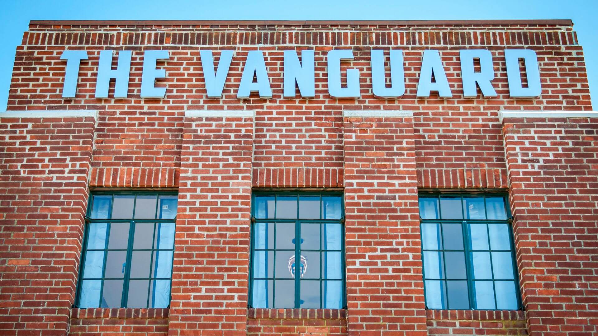 Brick exterior of The Vanguard, a brewery, restaurant, event venue, and distillery in Hampton, VA