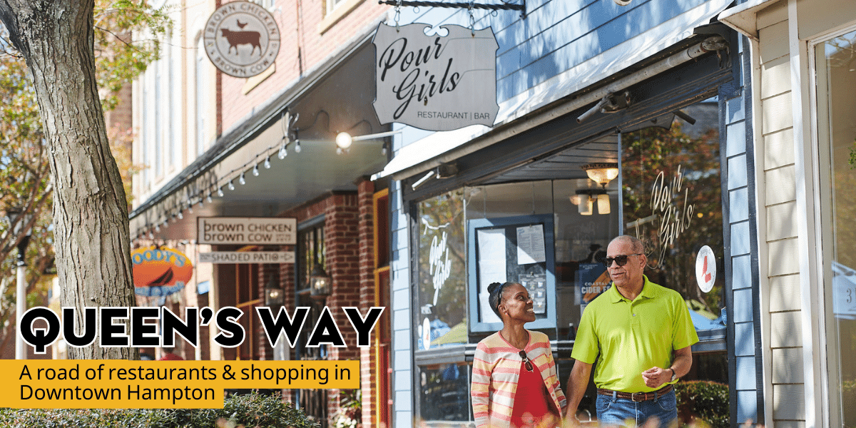 couple walking hand in hand down Queen's Way - A road of restaurants & shopping in downtown Hampton, VA